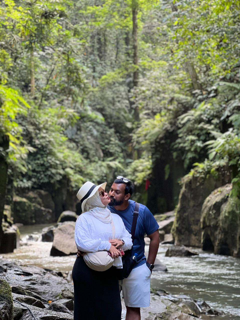 Couple by a river in a jungle gorge