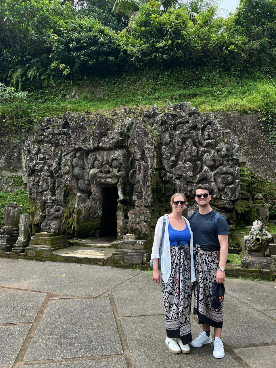 Couple in sarongs in front of Goa Gajah elephant cave, Ubud