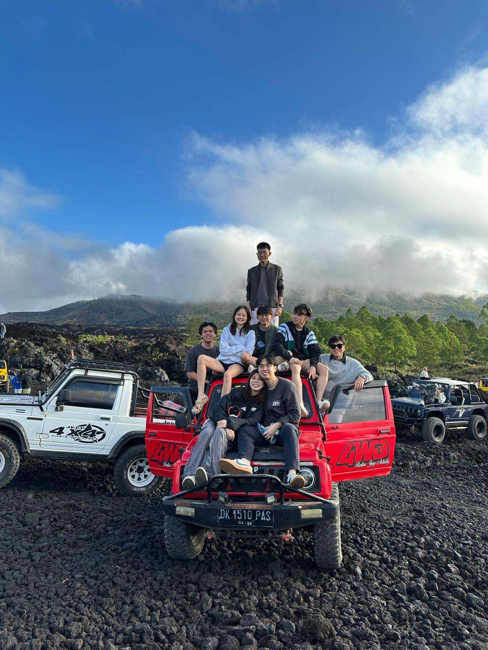 Group of guests on a jeep near black lava fields, Mount Batur