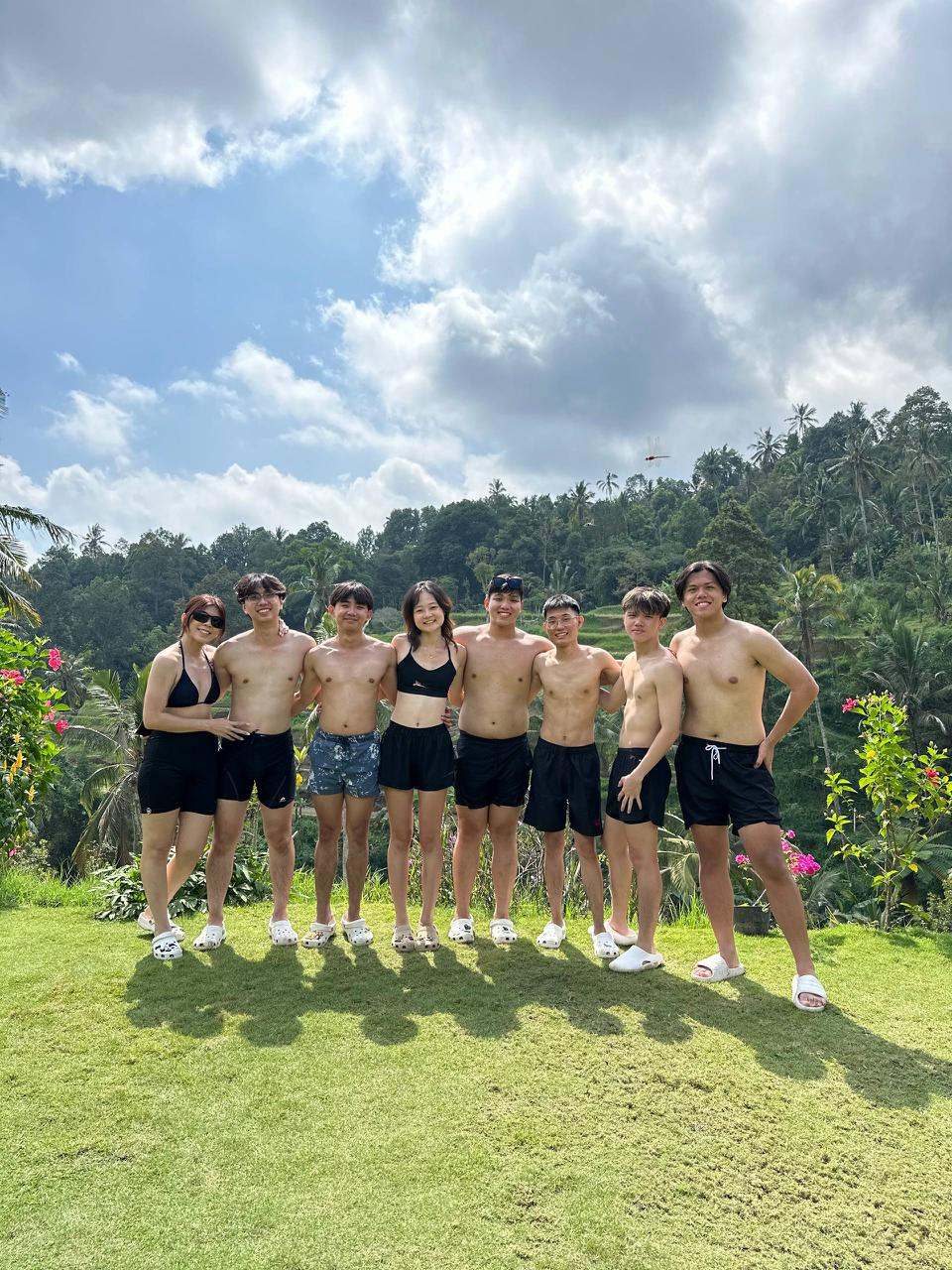 Group of guests on a lawn after a swim