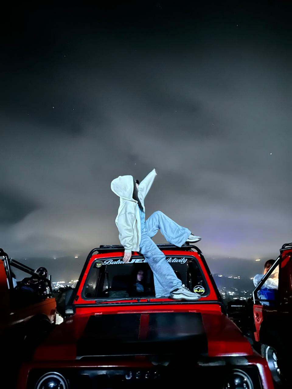 Guest posing on a jeep roof at night, Mount Batur