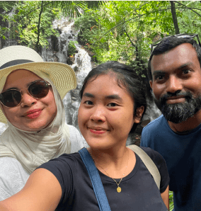 Guests taking a selfie with their Cahaya Bali Trip guide at a waterfall