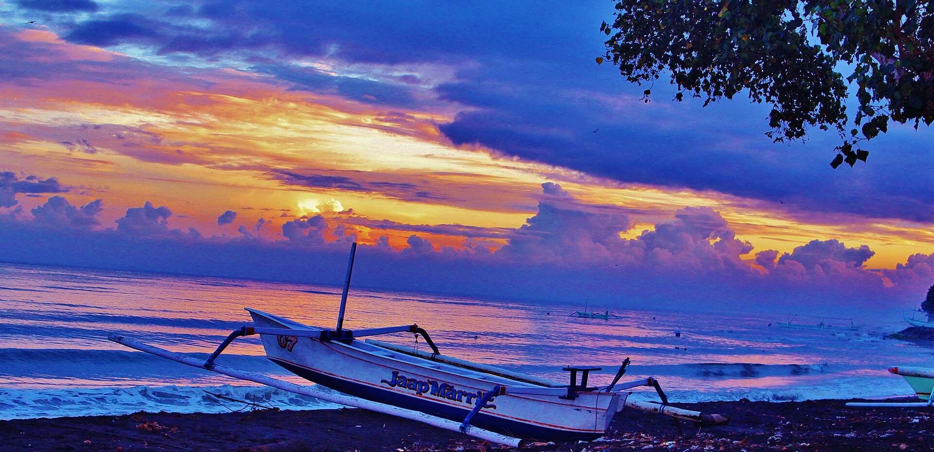 Jukung boat on the beach at sunrise in Lovina