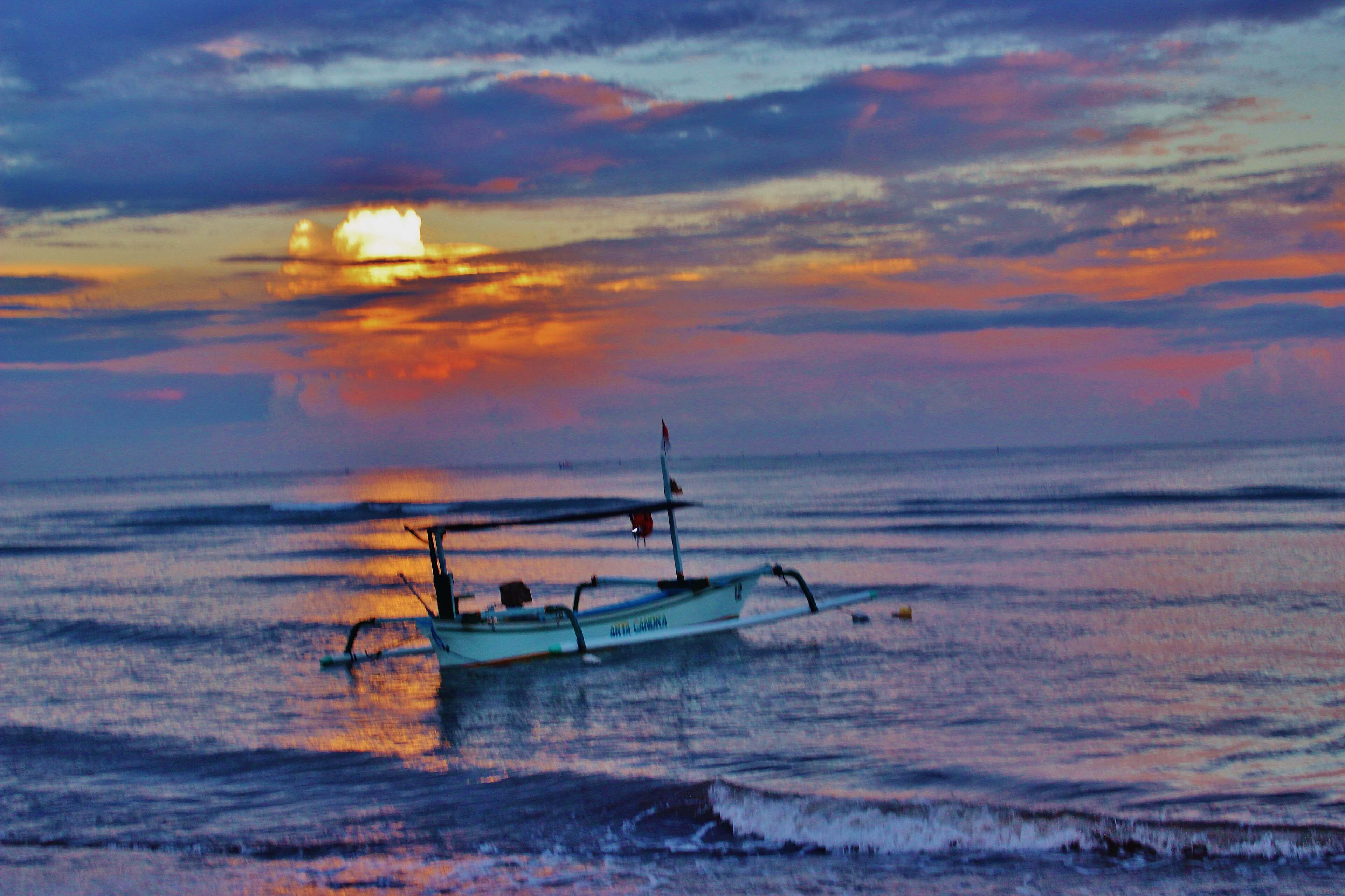 Jukung boat in the shallows at sunrise in Lovina